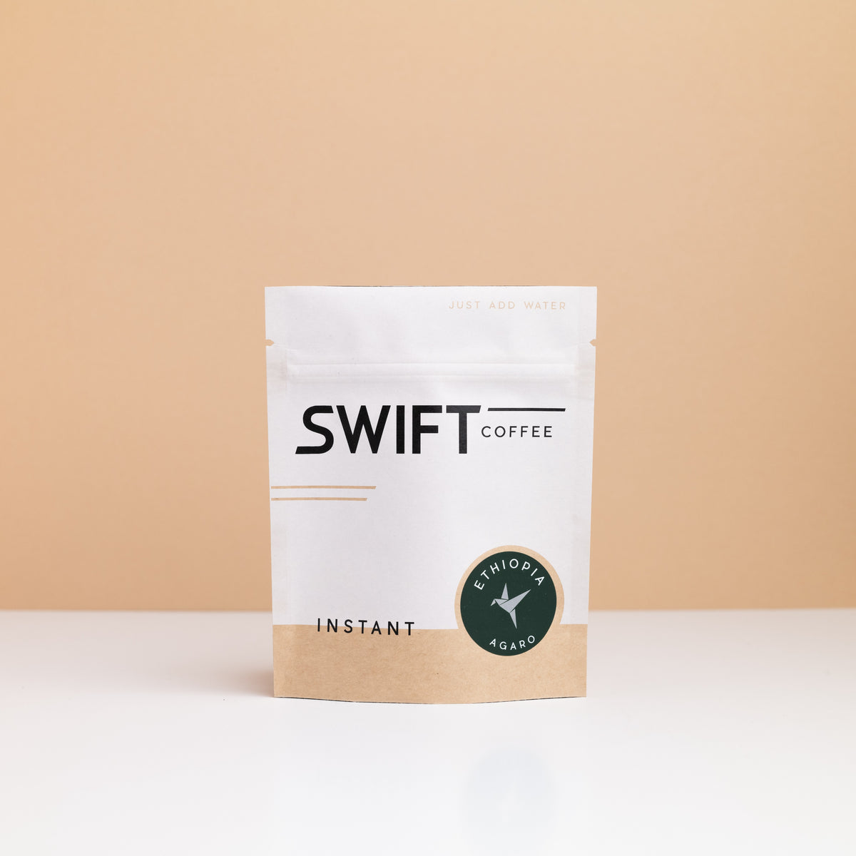 Small Swift Coffee Ethiopia Agaro instant coffee pouch on a tan backdrop