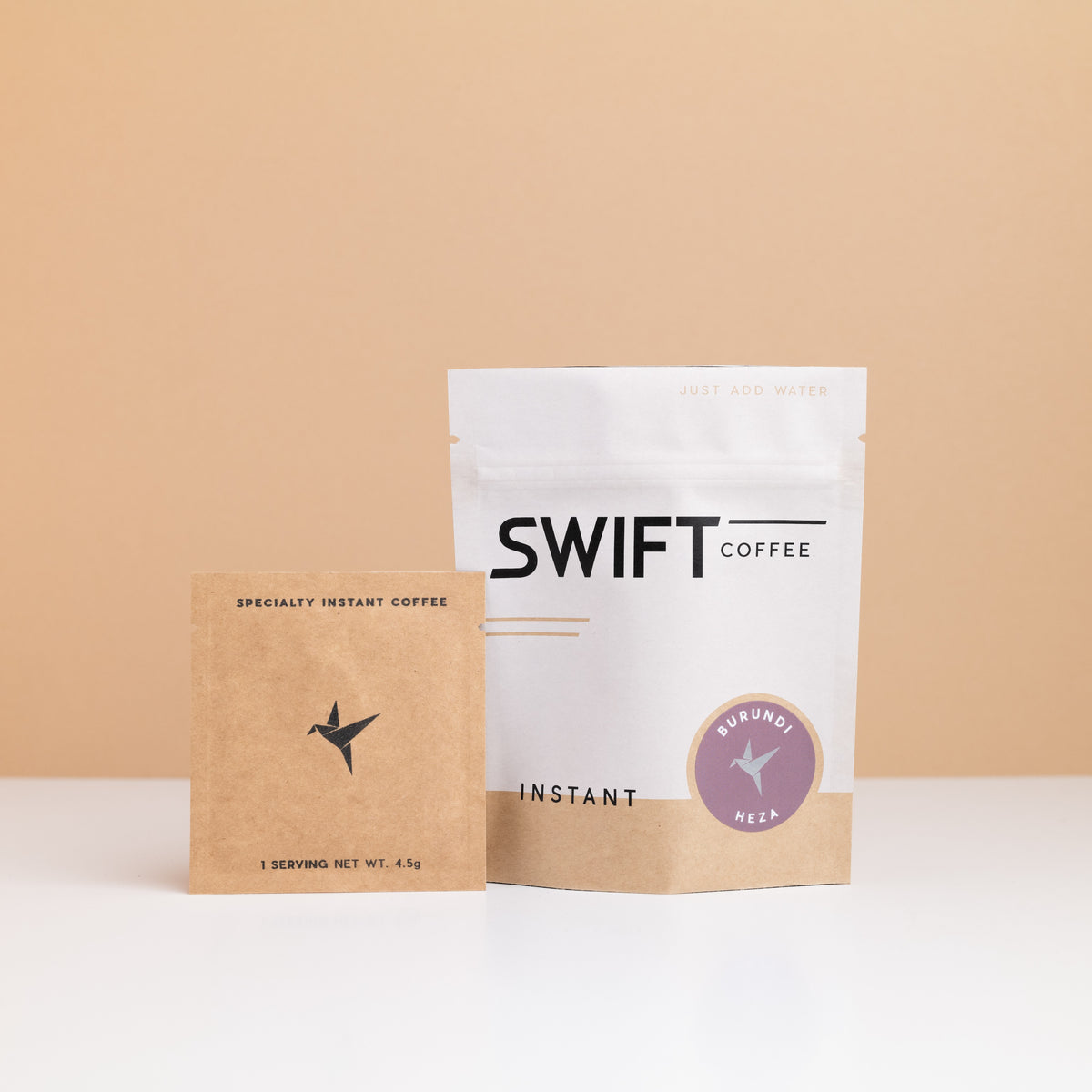 Swift Coffee Burundi – Heza instant coffee: white retail pouch with a mauve Burundi label and a kraft single-serve sachet