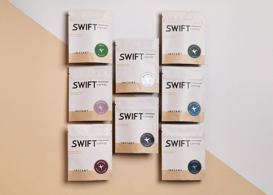 Eight Swift Coffee 6-cup instant coffee pouches, each with a different coffee label, arranged in a grid