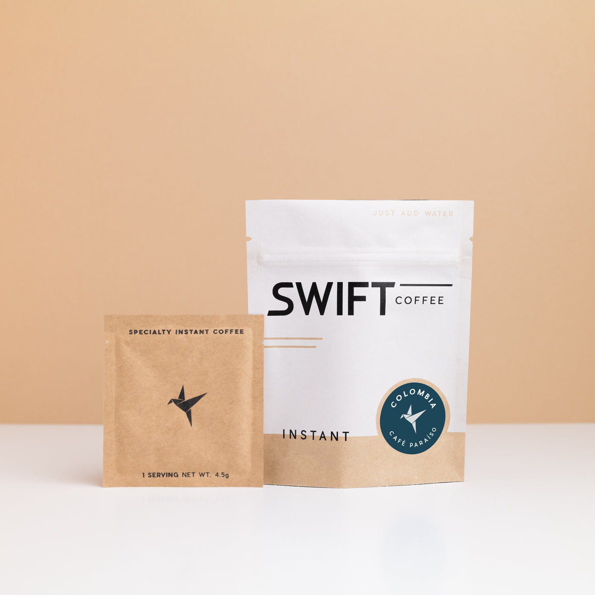Swift Coffee Colombia Cafe Paraiso instant coffee pouch with a kraft single-serve sachet in front