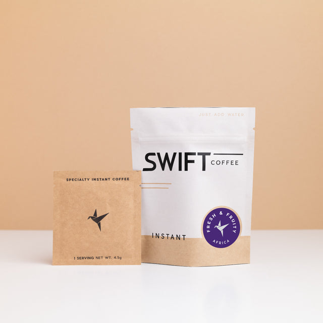 Swift Coffee Fresh & Fruity African Blend instant coffee: white pouch with a purple label and a kraft single-serve sachet