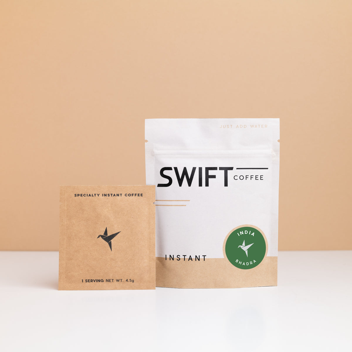 Swift Coffee India – Bhadra instant coffee: white pouch with a green India Bhadra label and a kraft single-serve sachet