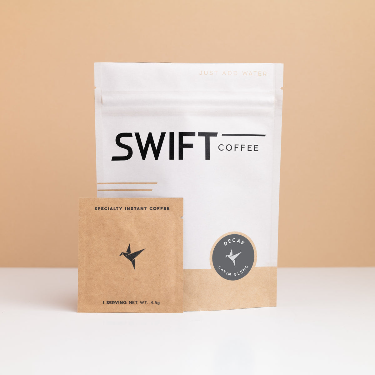 Swift Coffee Decaf Latin Blend instant coffee pouch with a kraft single-serve sachet in front