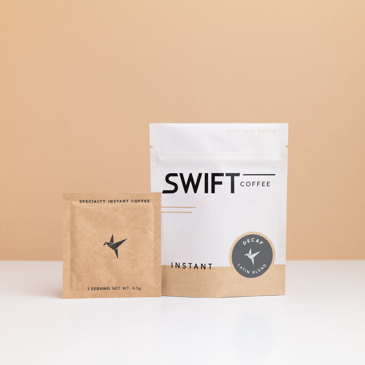 Swift Coffee Decaf – Latin Blend instant coffee: white pouch with a grey Decaf label and a kraft single-serve sachet