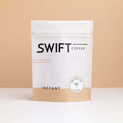 Swift Coffee Mainstay Blend instant coffee pouch on a tan backdrop