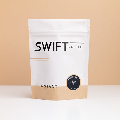 Swift Coffee Twilight Dark Roast instant coffee pouch on a tan backdrop
