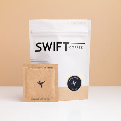 Swift Coffee Twilight Dark Roast instant coffee pouch with a kraft single-serve sachet in front