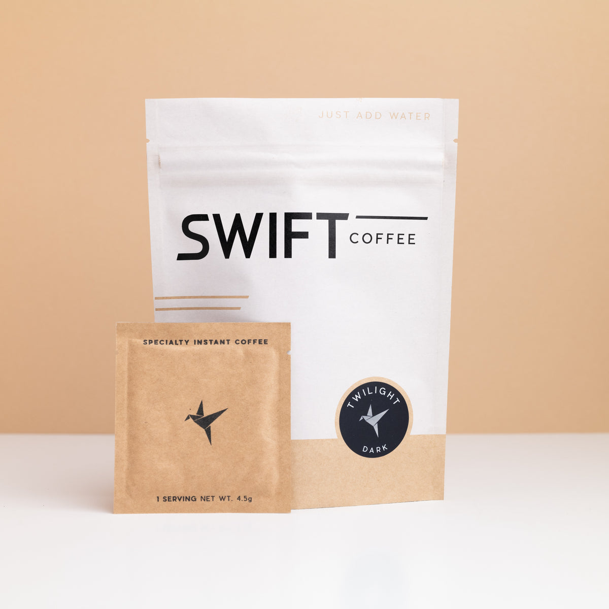 Swift Coffee Twilight Dark Roast instant coffee pouch with a kraft single-serve sachet in front