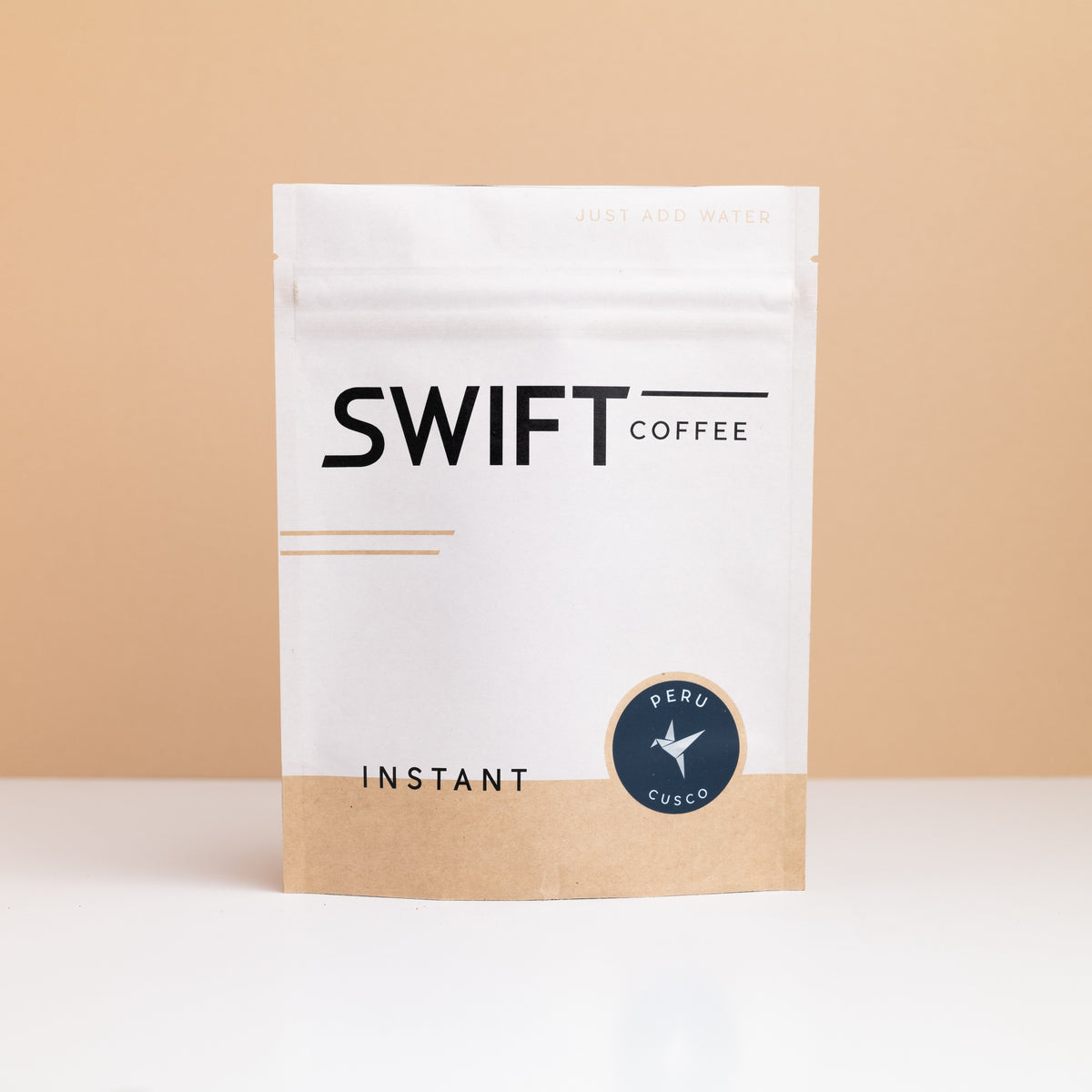 Swift Coffee Peru Cusco instant coffee pouch on a tan backdrop