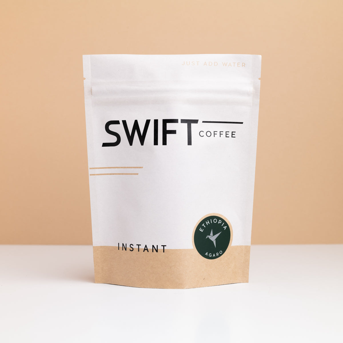 Swift Coffee Ethiopia Agaro instant coffee pouch on a tan backdrop
