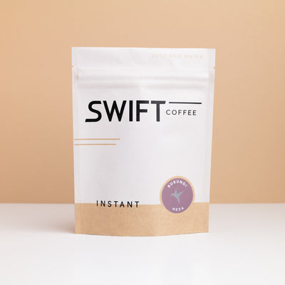 Swift Coffee Burundi Heza instant coffee pouch on a tan backdrop