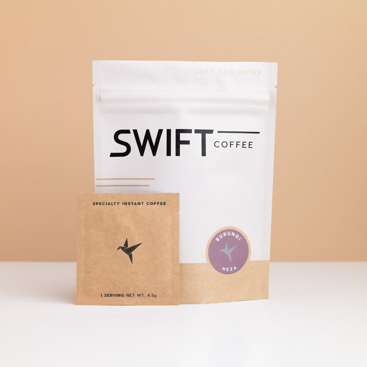 Swift Coffee Burundi Heza instant coffee pouch with a kraft single-serve sachet in front