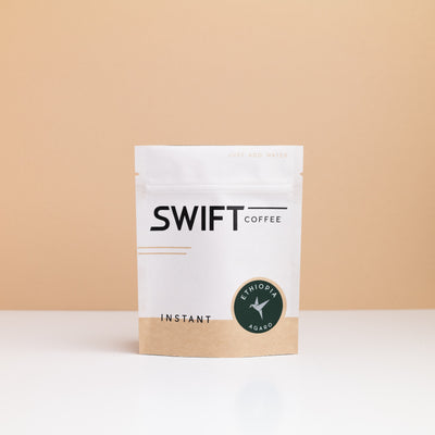 Small Swift Coffee Ethiopia Agaro instant coffee pouch on a tan backdrop