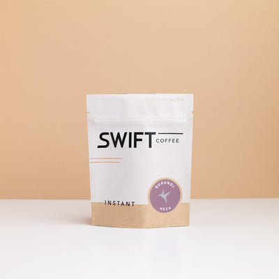 Small Swift Coffee Burundi Heza instant coffee pouch on a tan backdrop