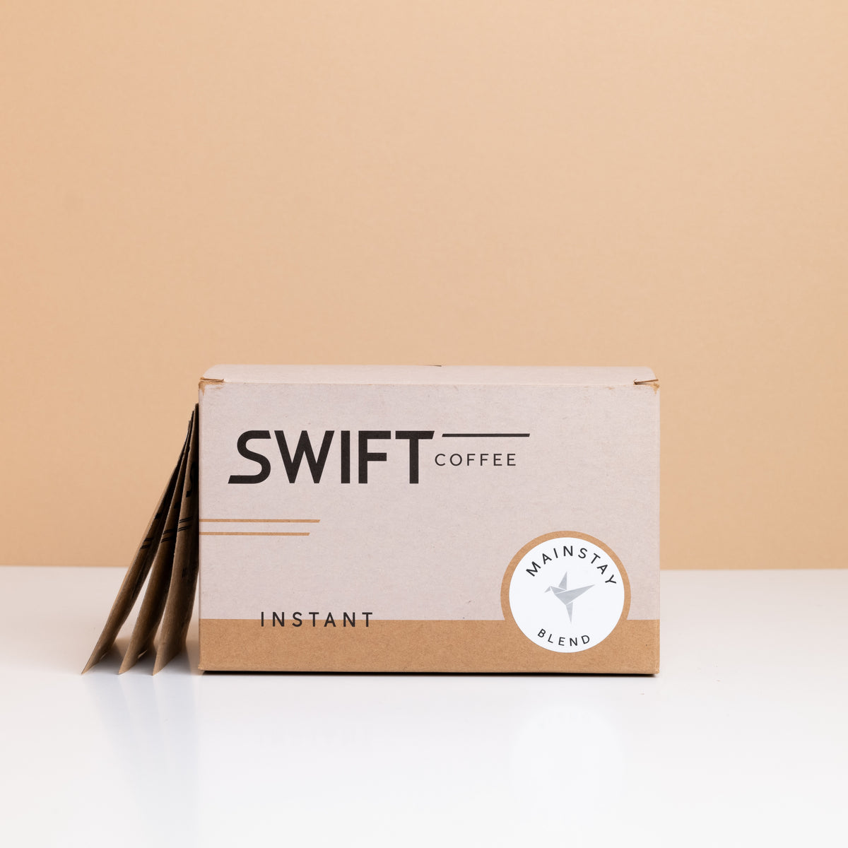 Box of Swift Coffee Mainstay Blend instant coffee with single-serve sachets leaning behind it