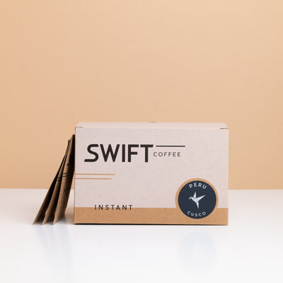 Box of Swift Coffee Peru Cusco instant coffee with single-serve sachets leaning behind it