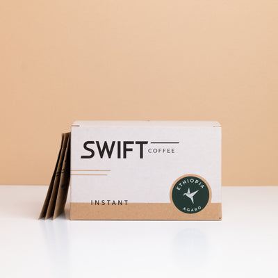 Box of Swift Coffee Ethiopia Agaro instant coffee with single-serve sachets leaning behind it
