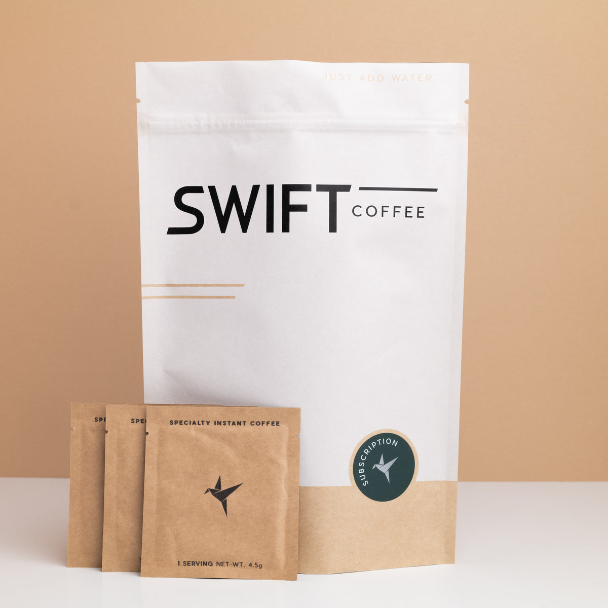 Swift Coffee Variety Pack instant coffee pouch with a stack of kraft single-serve sachets