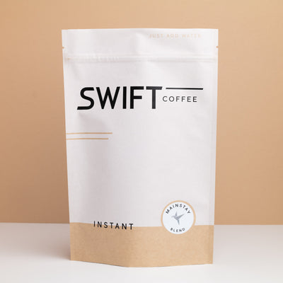 Swift Coffee Mainstay Blend instant coffee pouch on a tan backdrop