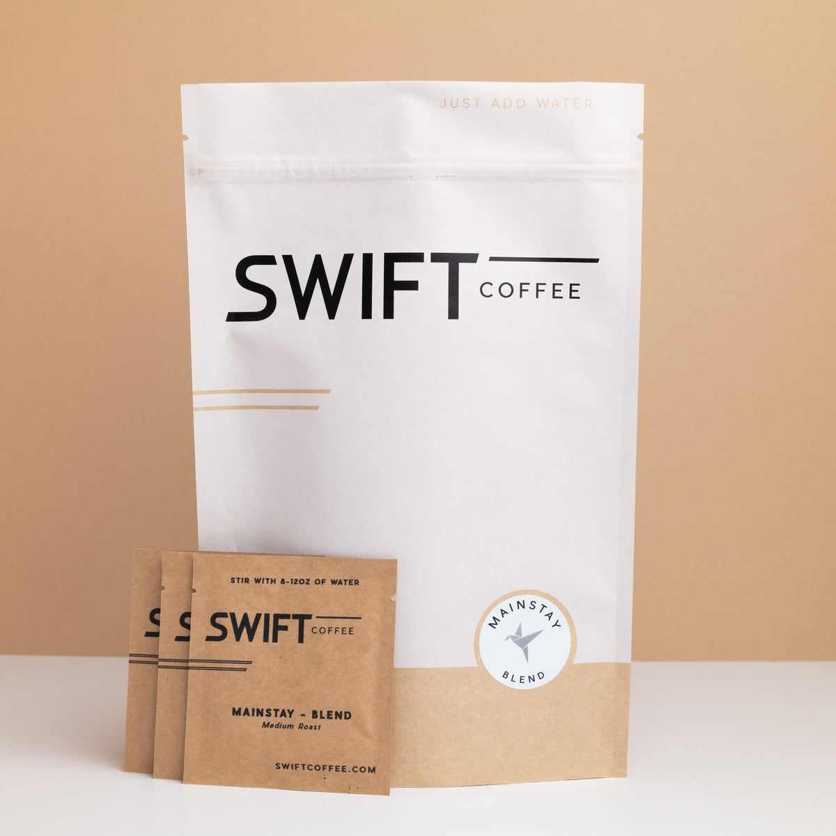 Swift Coffee Mainstay Blend subscription: large white pouch and three kraft sachets labeled Mainstay Blend, Medium Roast
