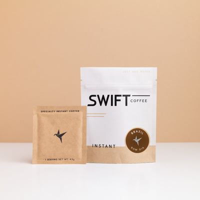 Swift Coffee Brazil - Bom Dia instant coffee: white pouch with a brown Brazil Bom Dia label and a kraft single-serve sachet