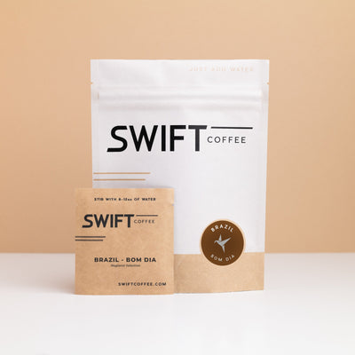 Swift Coffee Brazil Bom Dia instant coffee pouch with a labeled Brazil Bom Dia single-serve sachet in front