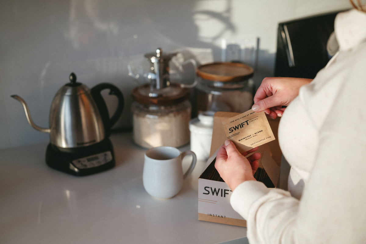 Making a cup of Swift instant coffee at a bright kitchen counter