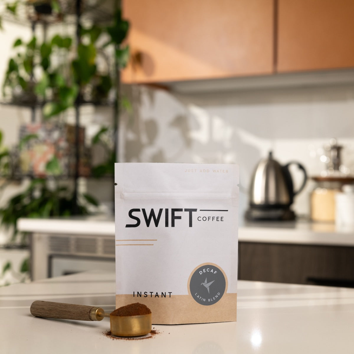 Swift Coffee Decaf Latin Blend instant coffee, 25-cup bulk pouch, on a kitchen counter