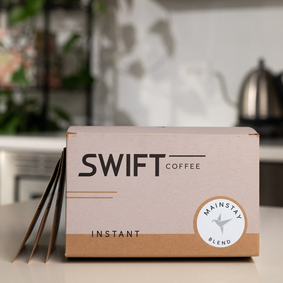 Swift Coffee Mainstay Blend 48-cup single serve box with sachets beside it on a kitchen counter