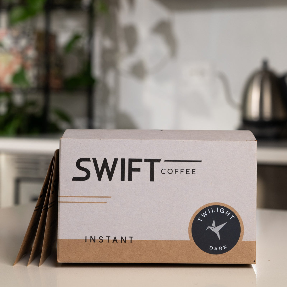 Swift Coffee Twilight Dark Roast 48-cup single serve box with sachets beside it on a kitchen counter