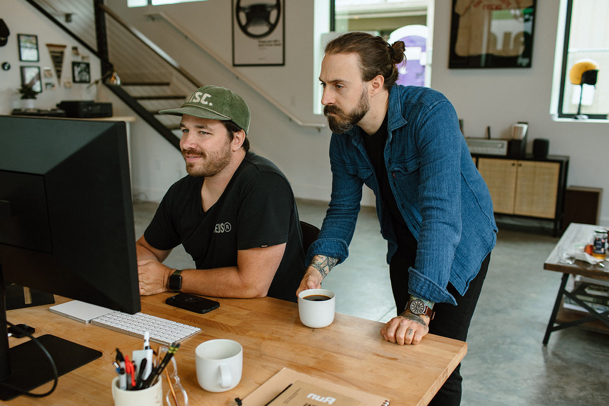Coworkers chatting over Swift coffee at their desks