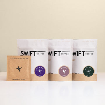 Swift Coffee East Africa Trio instant coffee pouches on an oat background