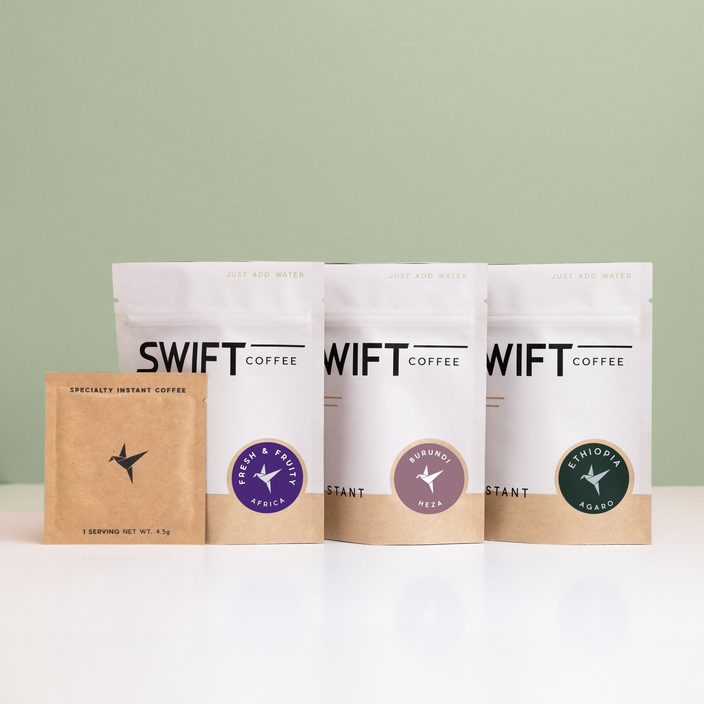 Swift Coffee East Africa Trio instant coffee pouches on a sage background