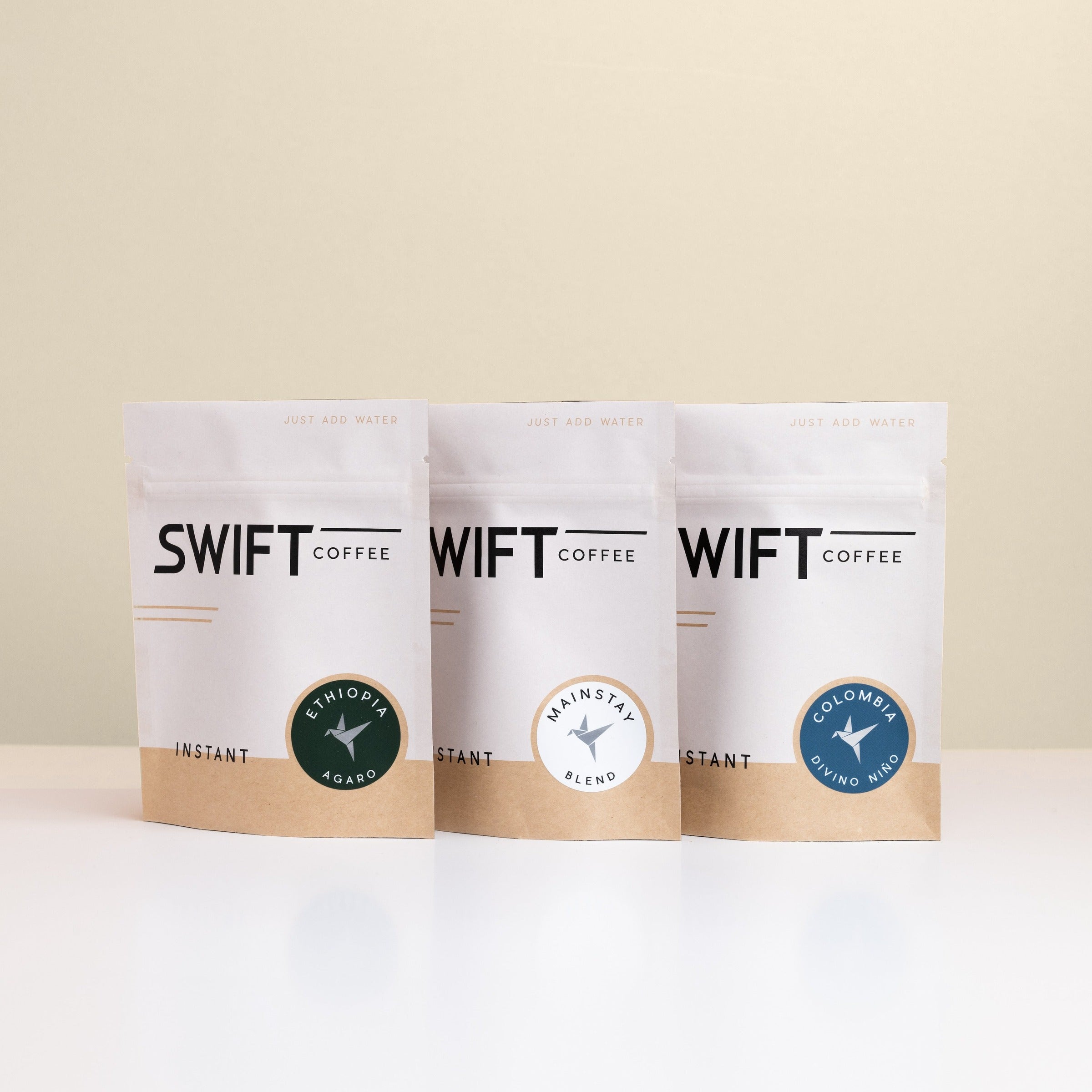 Swift Coffee The Essentials instant coffee pouches on an oat background