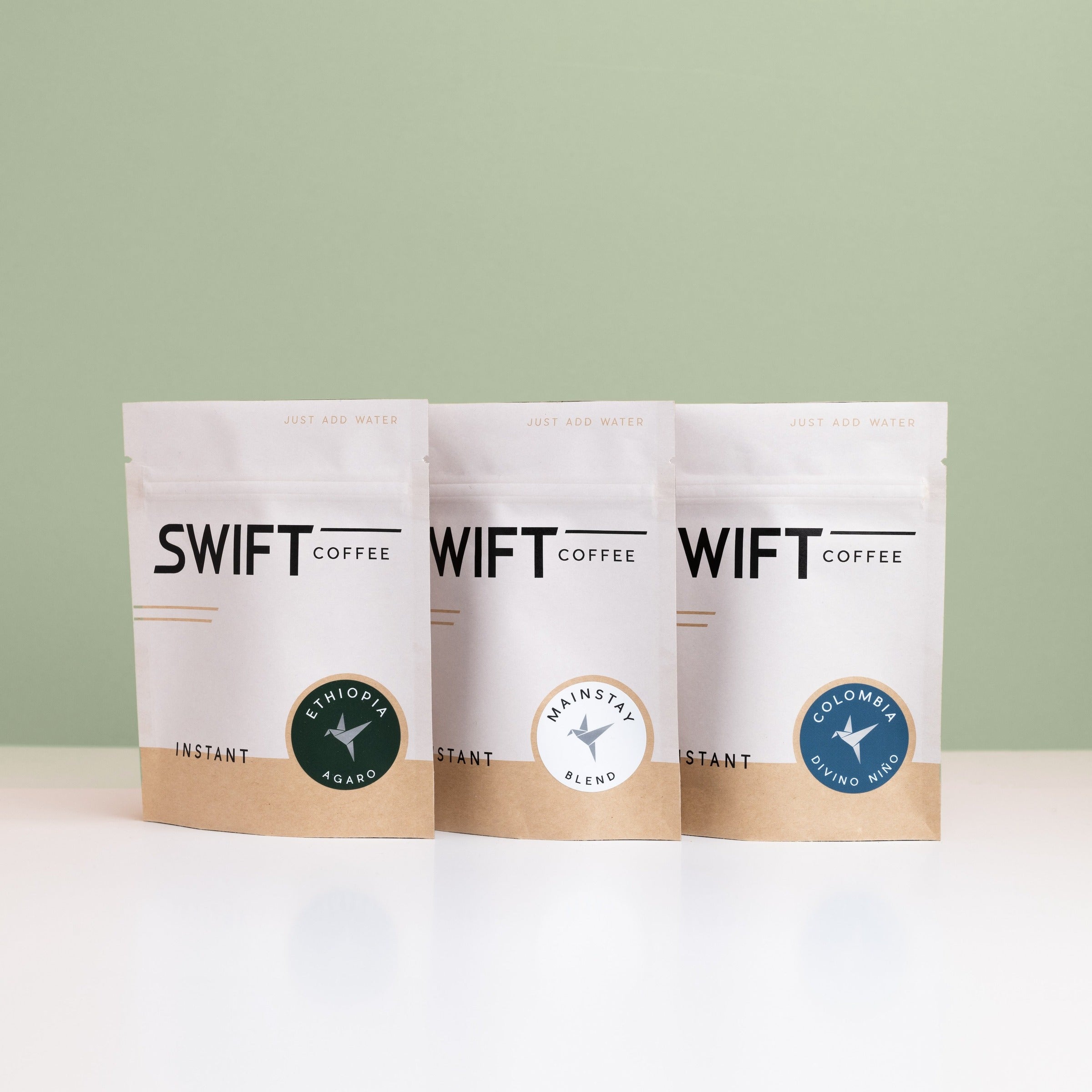 Swift Coffee The Essentials instant coffee pouches on a sage background