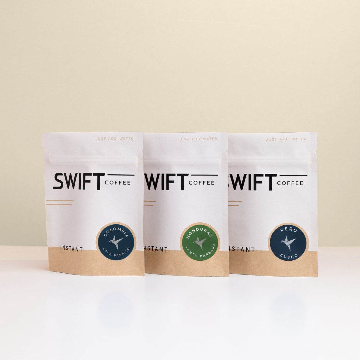 Swift Coffee Latin American Trio instant coffee pouches on an oat background