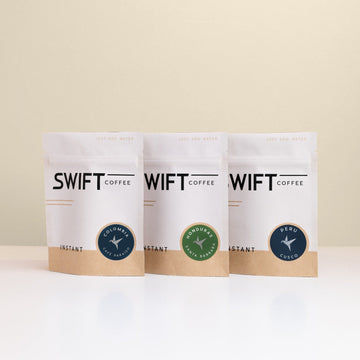 Swift Coffee Latin American Trio instant coffee pouches on an oat background