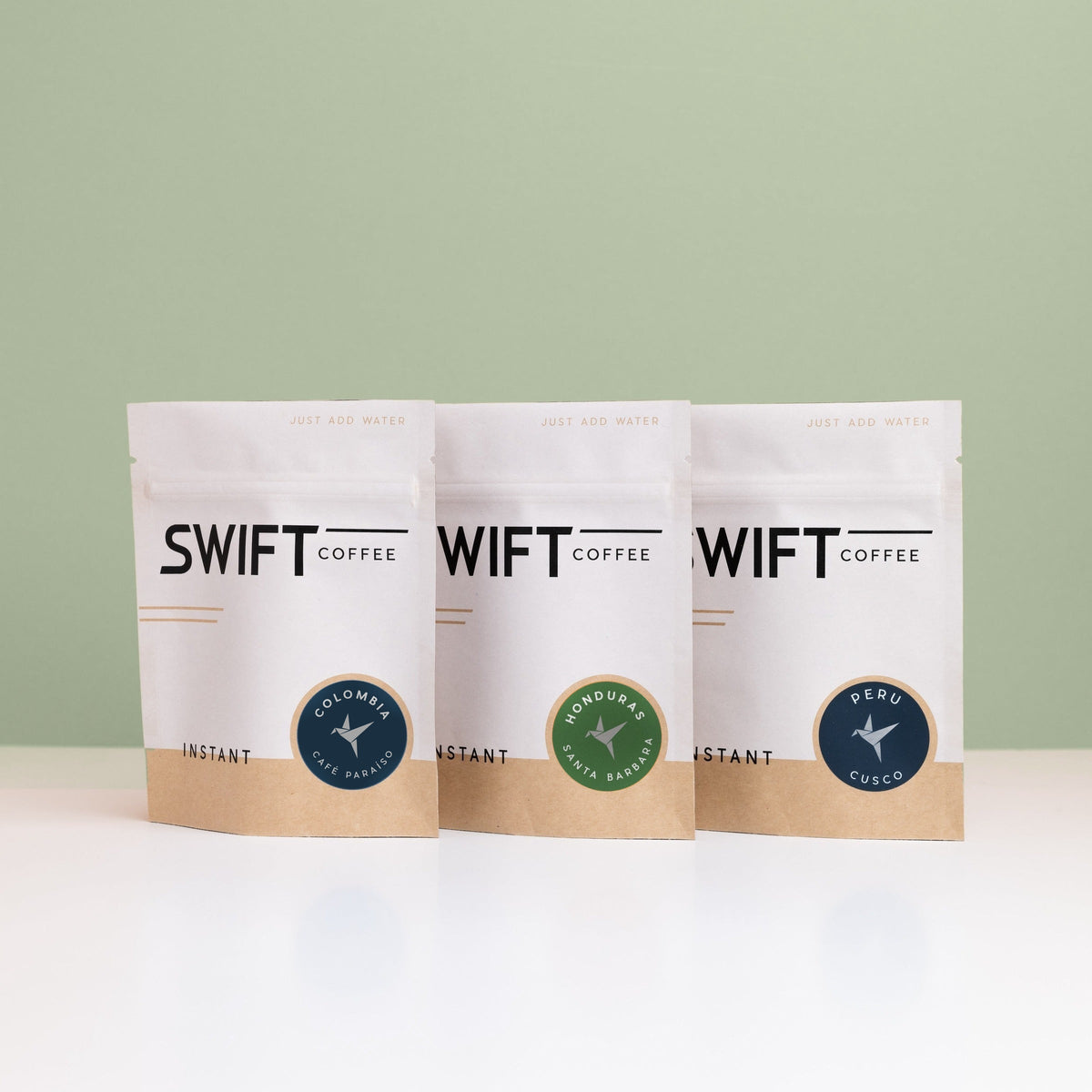 Swift Coffee Latin American Trio instant coffee pouches on a sage background