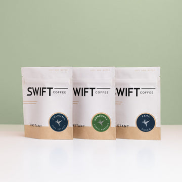 Swift Coffee Latin American Trio instant coffee pouches on a sage background