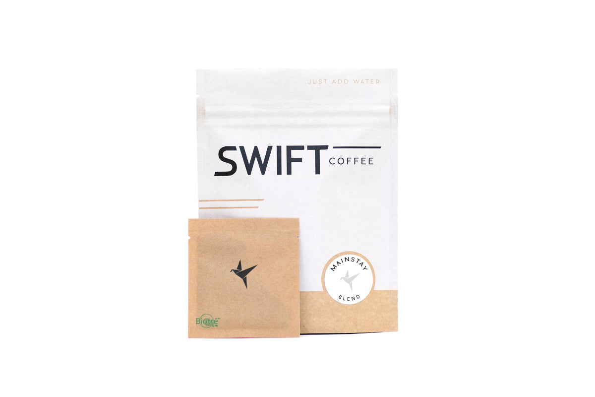 Swift Coffee Mainstay Blend instant coffee pouch with a kraft single-serve sachet, on a white background