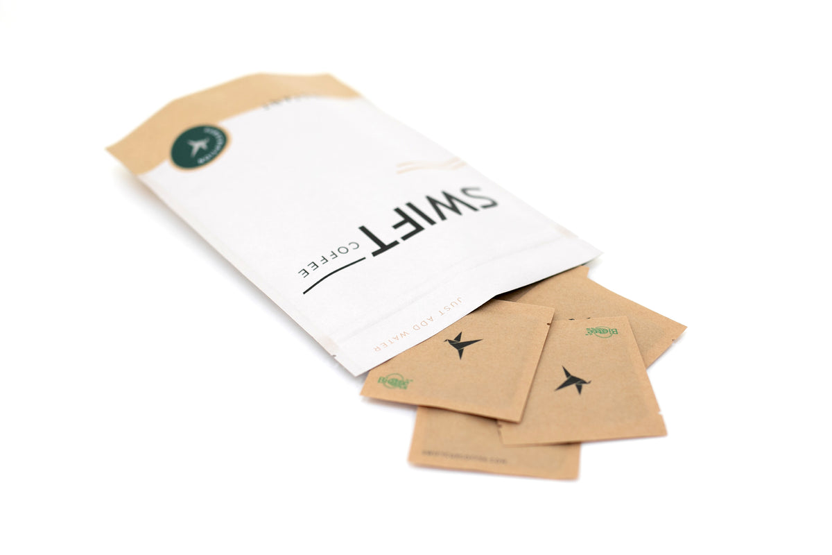 Swift Coffee Variety Pack instant coffee pouch lying on its side with kraft single-serve sachets spilling out